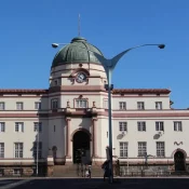 Il serait dommage de manquer Bulayawo lors de votre visite du Zimbabwe.
La ville est la deuxième du pays et était la capitale du royaume Ndébélé fondé au XIXème siècle.
Son centre historique est réputé car il a conservé les traces de l’occupation européenne et de nombreux édifices de style colonial, certains très étonnants, subsistent, ce qui apporte un certain charme.
Sur le plan culturel, Bulawayo est également connue pour ses très beaux musées.
En effet, le musée d’Histoire Naturelle est très riche et ses collections comptent parmi les plus importantes du continent.
La faune et la flore du pays y sont présentées, les différentes civilisations et les personnages qui ont marqué l’histoire du Zimbabwe.
En prime, une mine d’or a été reconstituée parmi de nombreuses autres curiosités.
L’autre musée célèbre de la ville est celui des chemins de fer.
Il retrace l’histoire de la colonisation et de ses projets pharaoniques, à travers la présentation d’anciens wagons.
Vous pouvez y découvrir celui qui a traversé pour la première fois le pont des chutes Victoria ou encore celui de Cecil Rhodes.
Pour terminer en beauté votre découverte de la ville, il ne faut pas manquer de vous rendre en périphérie pour visiter les vestiges de la cité de Khami qui s’est développée après la chute de Grand Zimbabwe.